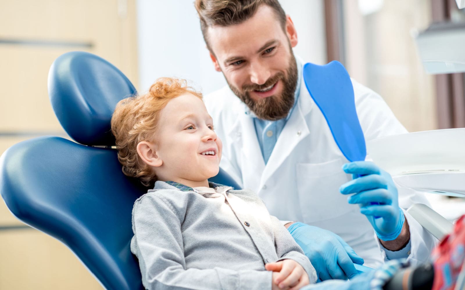 Pediatric Dentist Caring For Child Patient