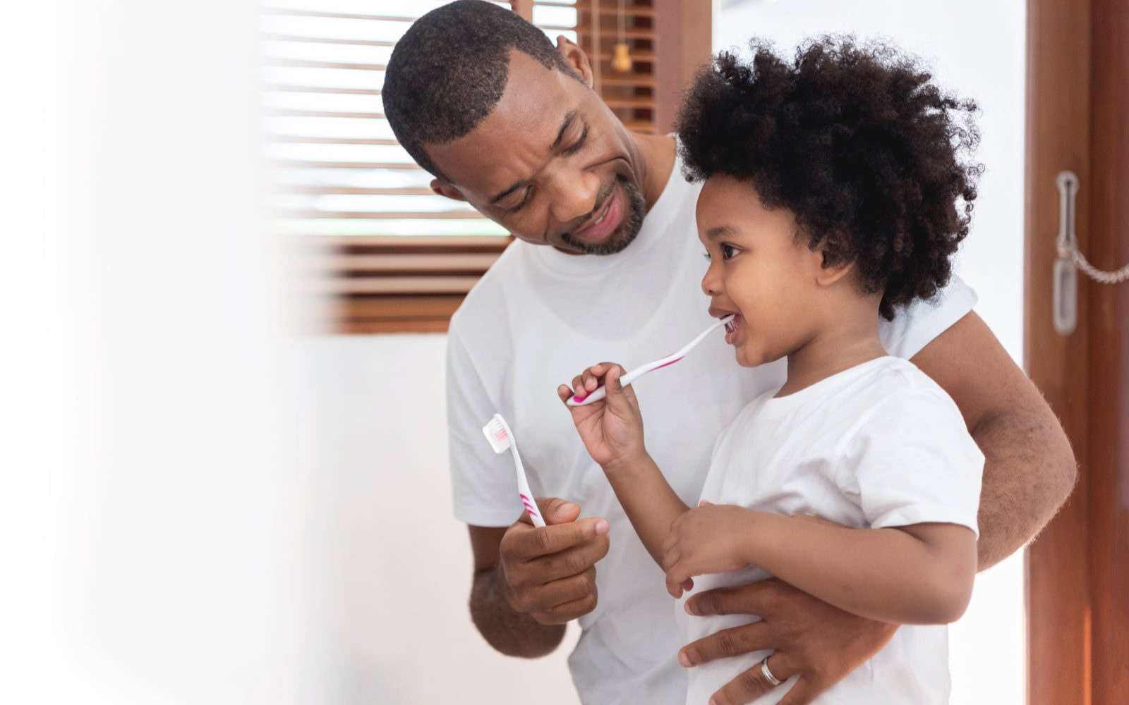 Father Caring For Child's Oral Health