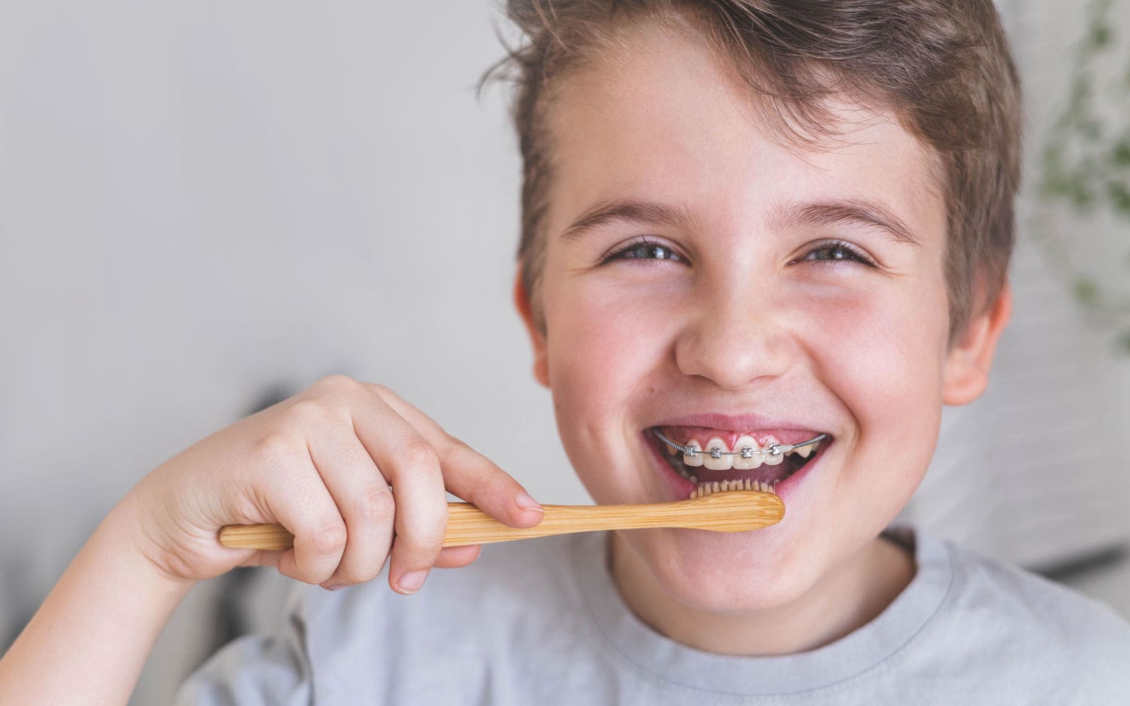 Boy Brushing Teeth with Braces Smiling